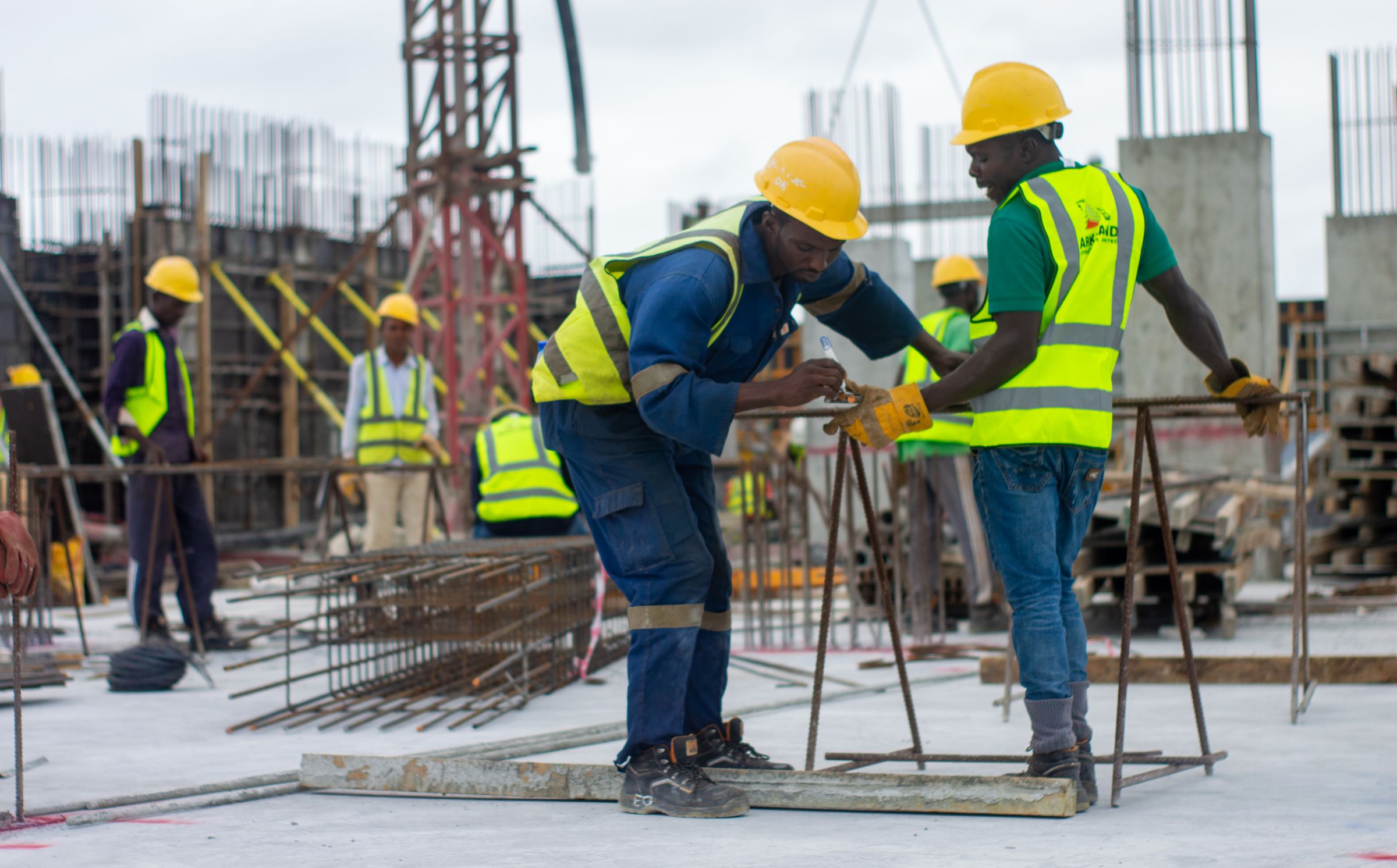 Construction team wearing hard hats on a reinforced concrete building site