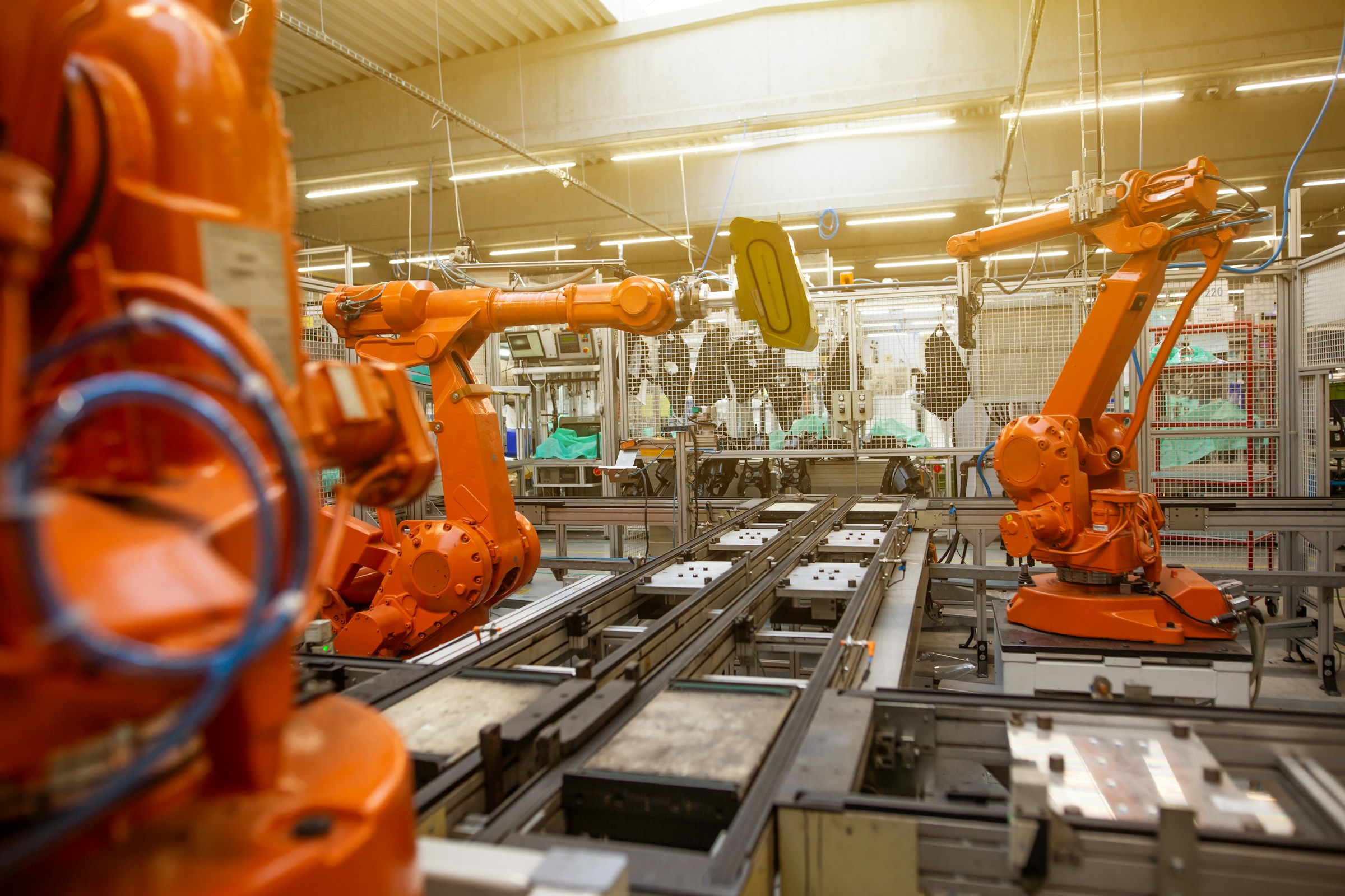 Industrial robotic arms working on an automated factory production line