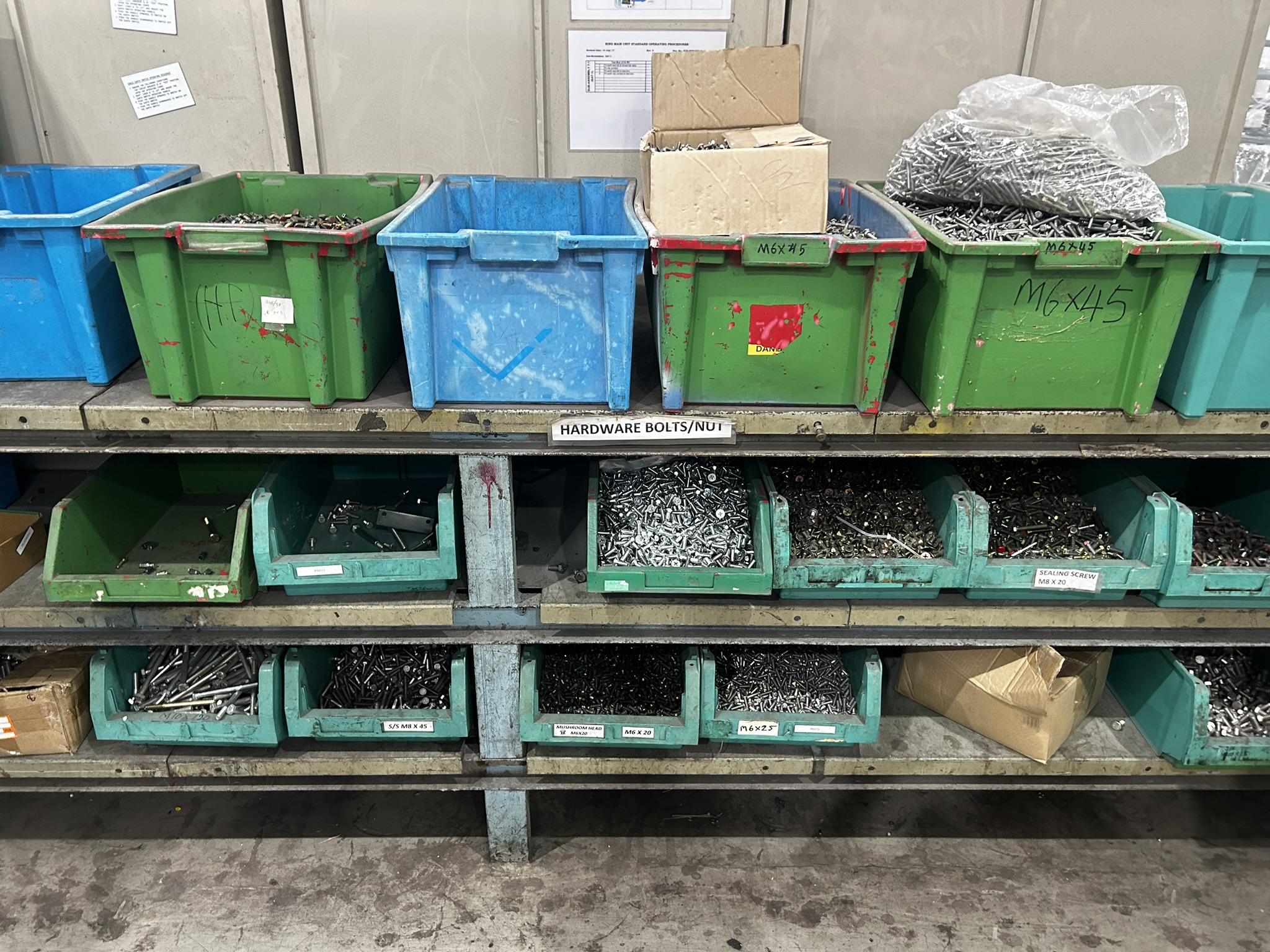 Open bins holding different quantities of industrial fasteners